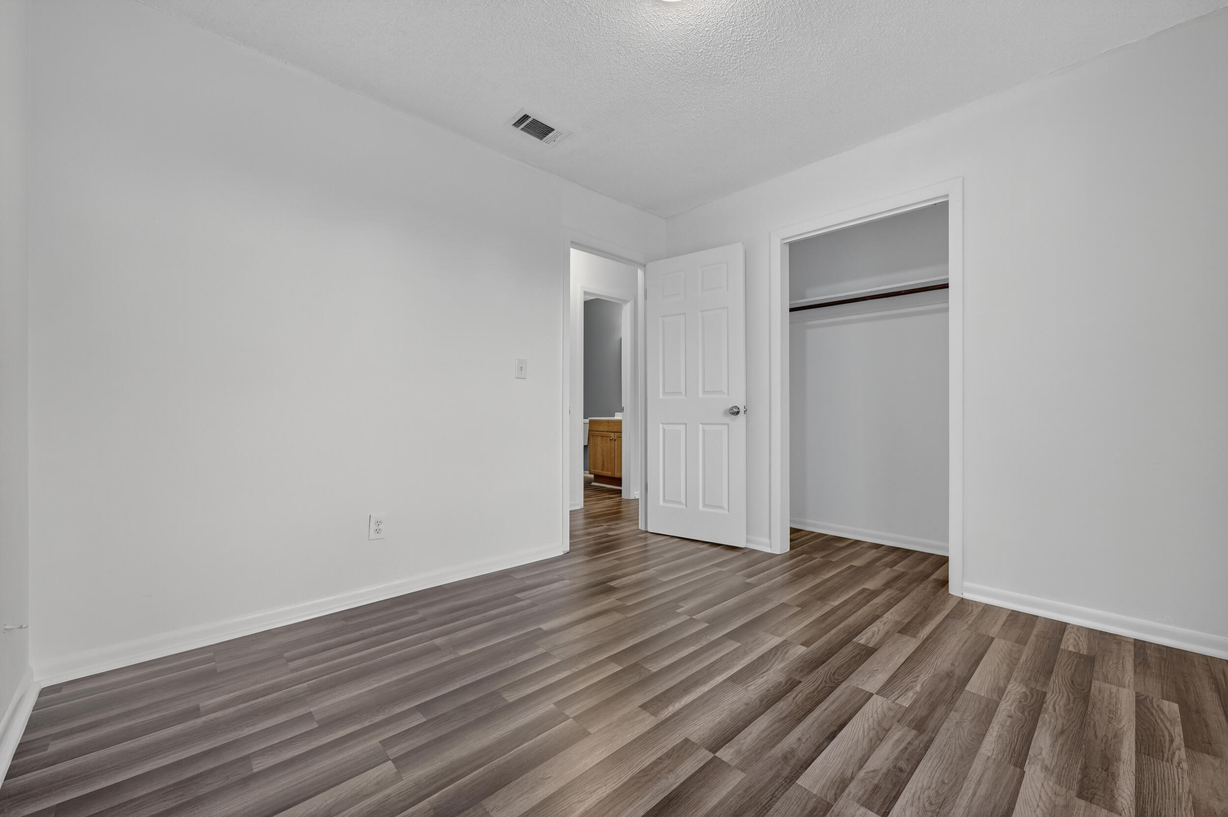 552 Roberts Drive DeFuniak Springs, FL 32433 - Photo 28 of 40 a view of an empty room with wooden floor and closet
