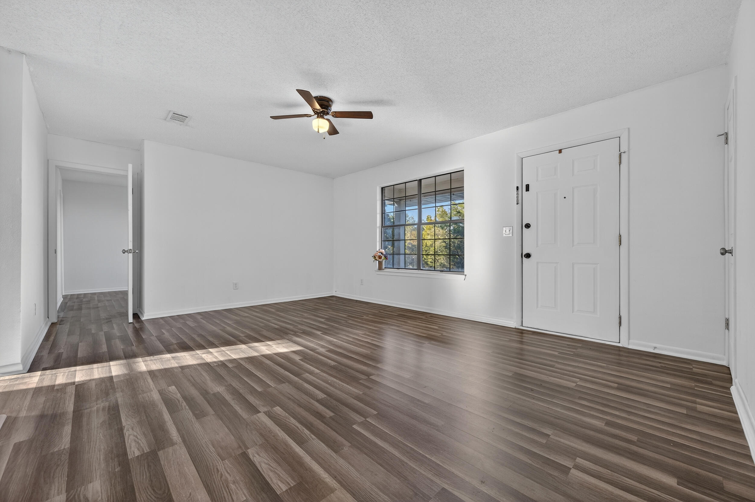 552 Roberts Drive DeFuniak Springs, FL 32433 - Photo 6 of 40 a view of empty room with wooden floor and fan