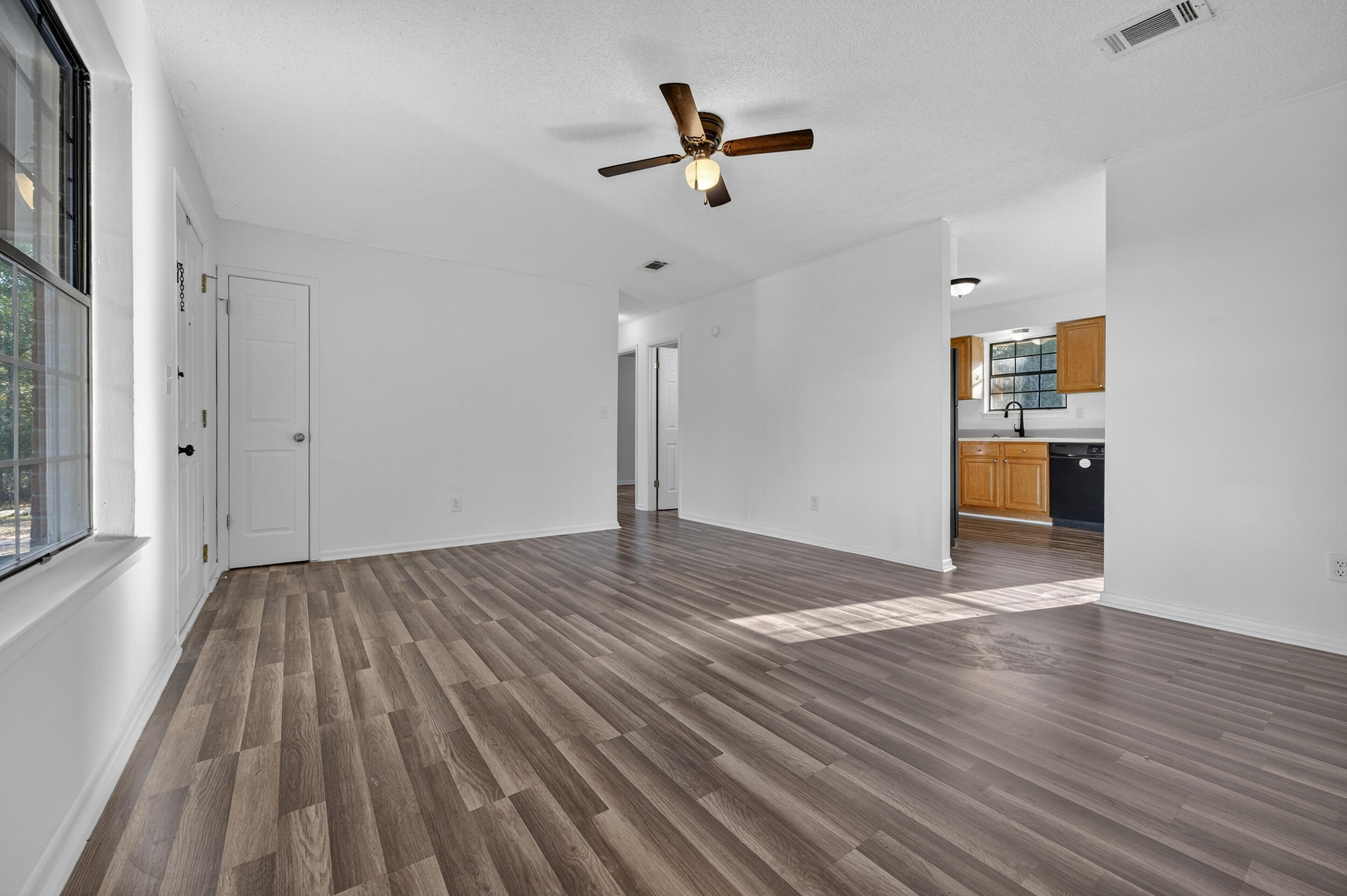 552 Roberts Drive DeFuniak Springs, FL 32433 - Photo 7 of 40 a view of empty room with wooden floor and ceiling fan