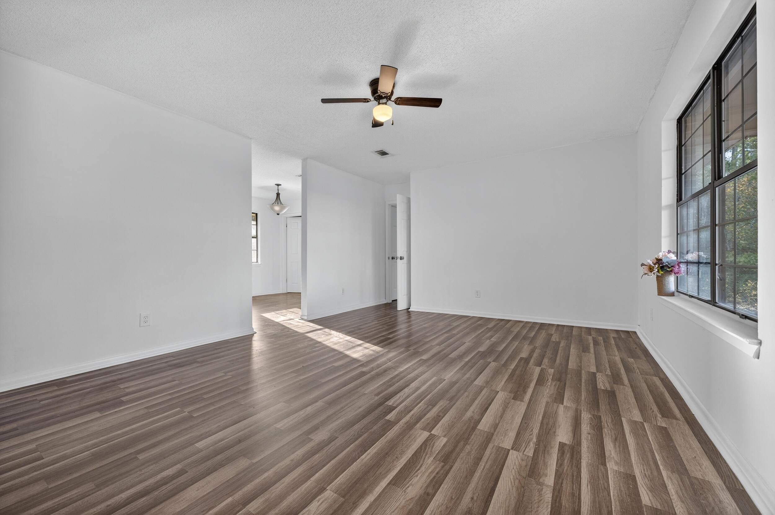 552 Roberts Drive DeFuniak Springs, FL 32433 - Photo 8 of 40 wooden floor in an empty room with a window