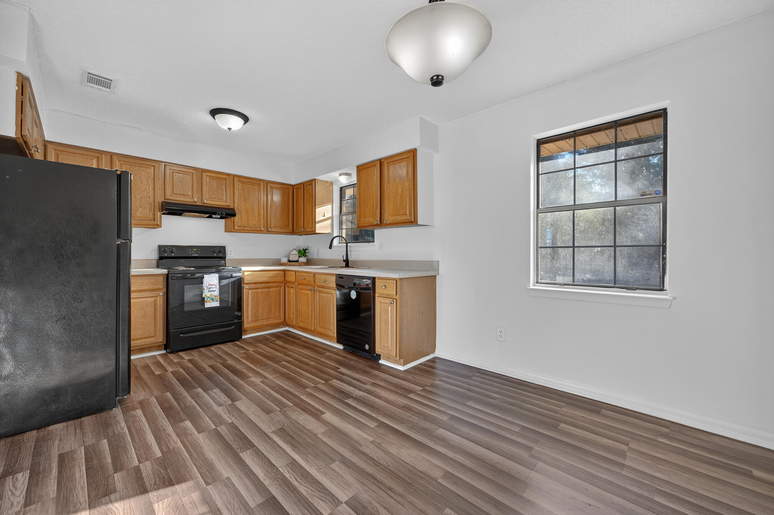 552 Roberts Drive DeFuniak Springs, FL 32433 - Photo 10 of 40 a kitchen with stainless steel appliances granite countertop a stove a sink and a refrigerator