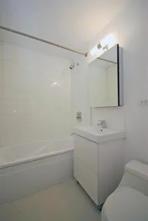 a bathroom with a sink a toilet and mirror