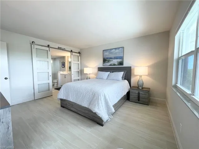 a bedroom with a bed and a night stand