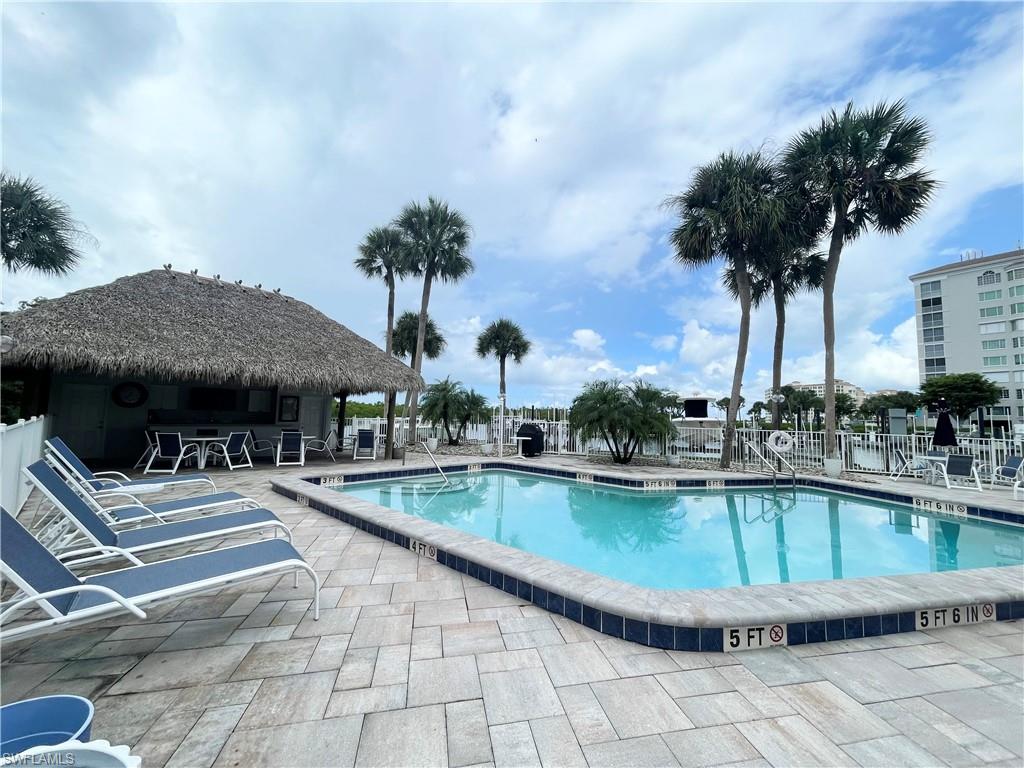 12945 Vanderbilt Drive, Unit 403 Naples, FL 34110 - Photo 38 of 42 a view of a swimming pool with a patio