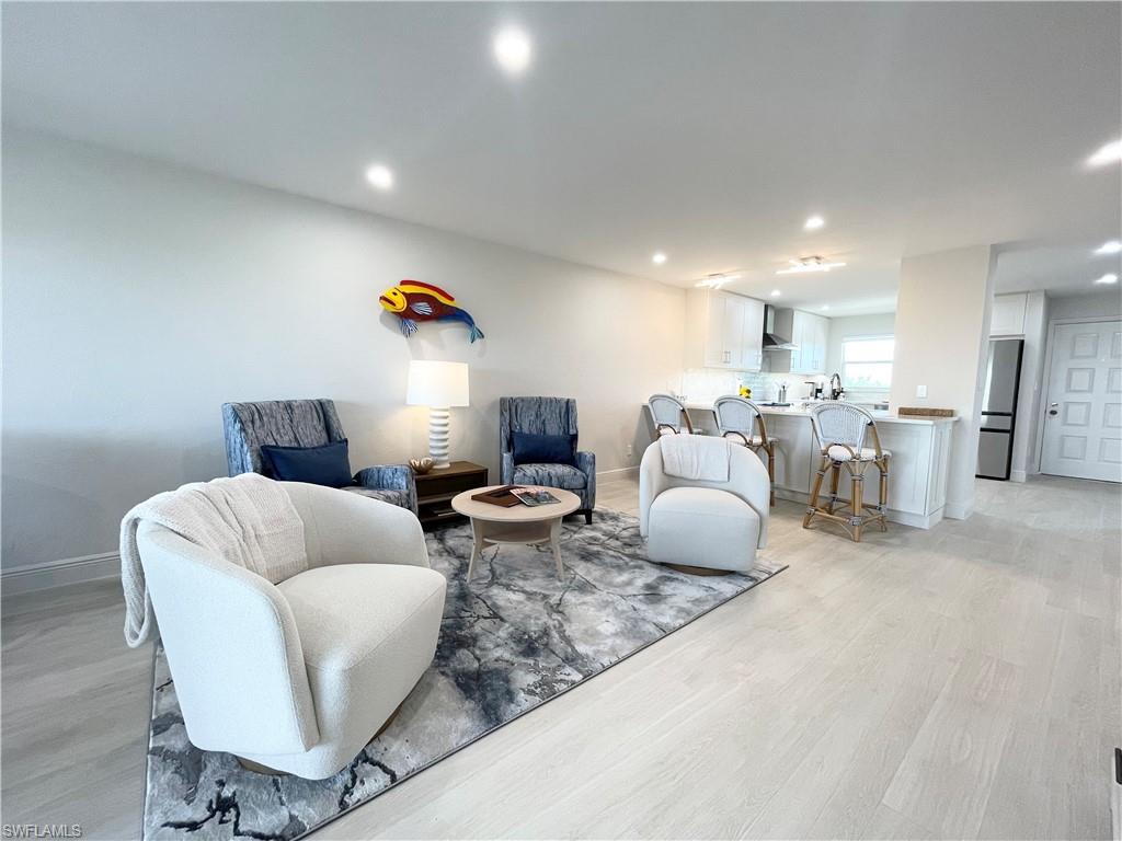 12945 Vanderbilt Drive, Unit 403 Naples, FL 34110 - Photo 7 of 42 a living room with furniture