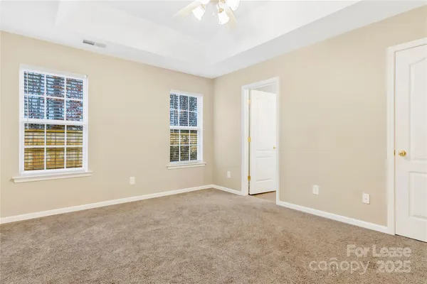 an empty room with windows and closet