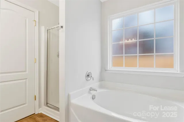 a white bath tub sitting next to a window