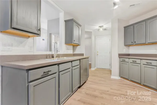 a spacious bathroom with a sink and a mirror
