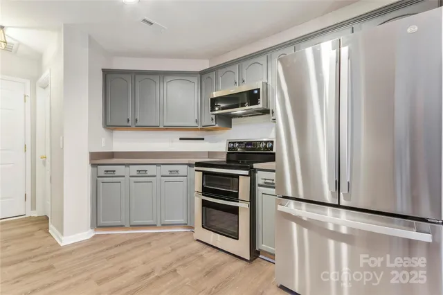 a kitchen with stainless steel appliances a stove and a refrigerator