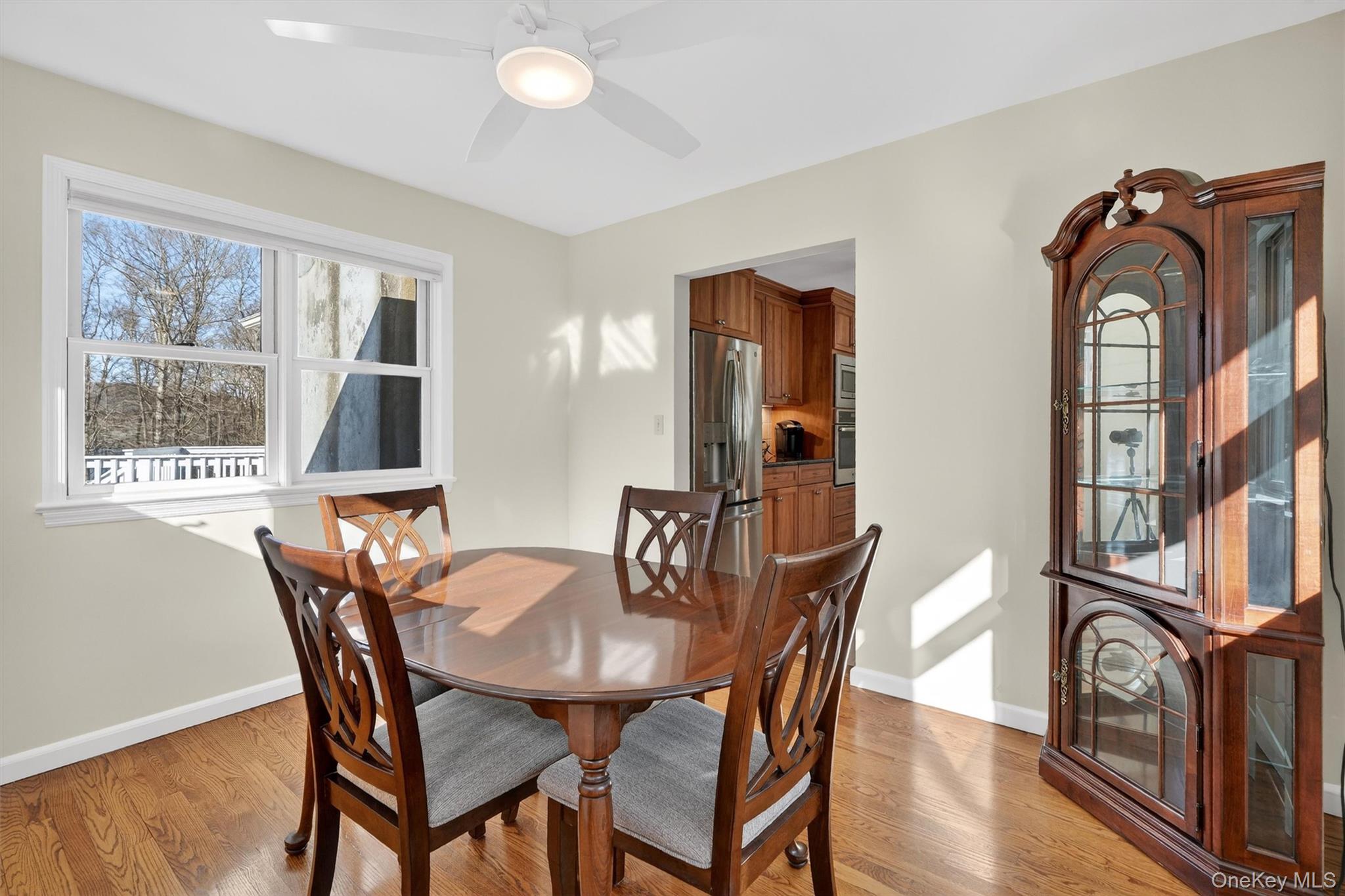 1166 Hunterbrook Road Yorktown Heights, NY 10598 - Photo 11 of 36 a view of a dining room with furniture window and wooden floor