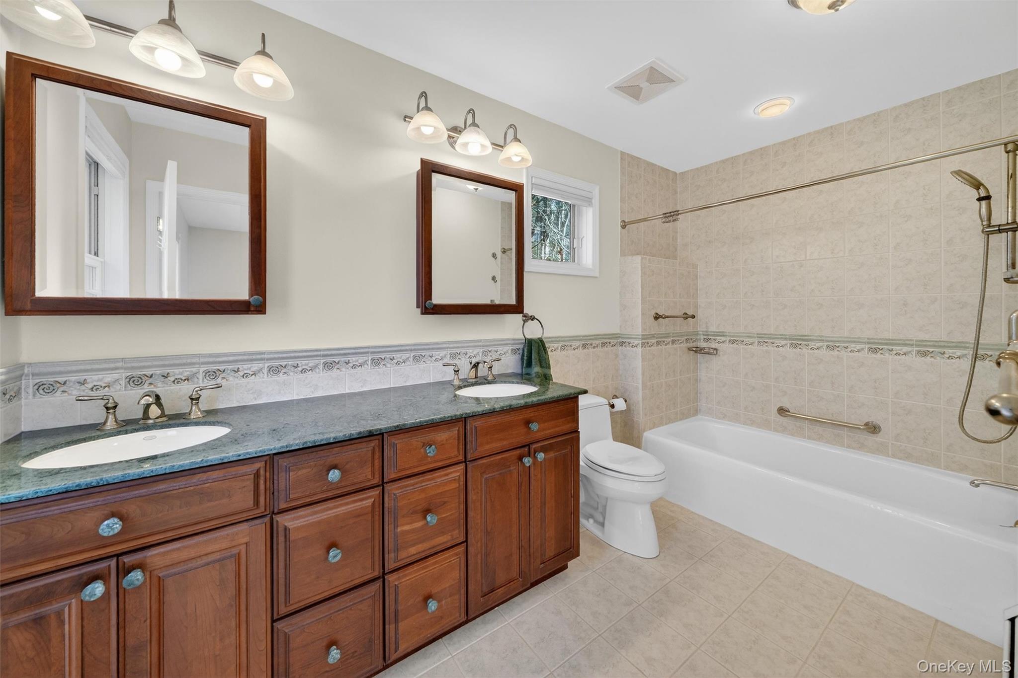 1166 Hunterbrook Road Yorktown Heights, NY 10598 - Photo 14 of 36 a bathroom with a double vanity sink toilet mirror and bathtub