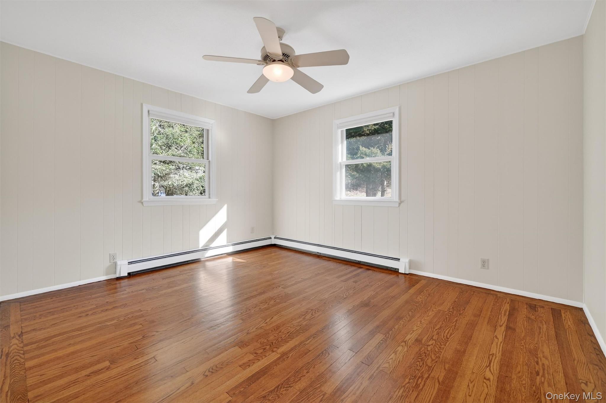 1166 Hunterbrook Road Yorktown Heights, NY 10598 - Photo 17 of 36 wooden floor in an empty room with a window
