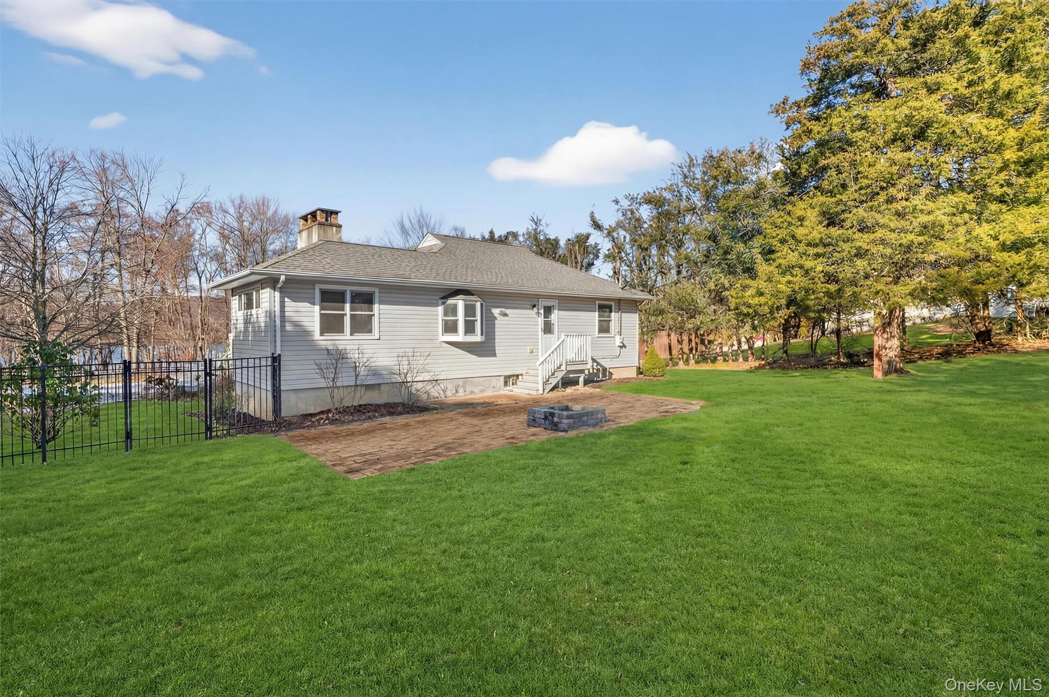 1166 Hunterbrook Road Yorktown Heights, NY 10598 - Photo 26 of 36 a front view of a house with a garden and trees
