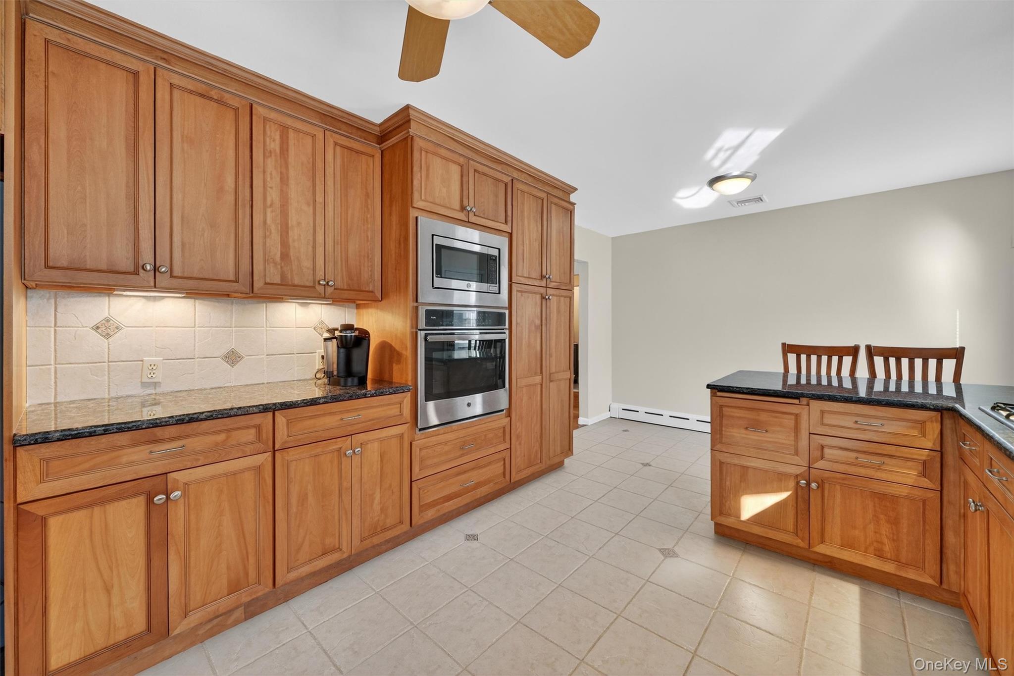 1166 Hunterbrook Road Yorktown Heights, NY 10598 - Photo 8 of 36 a kitchen with granite countertop a stove a sink and a cabinets