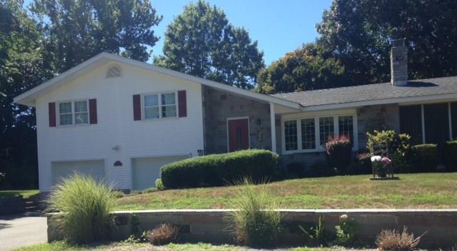 a front view of house with yard and green space