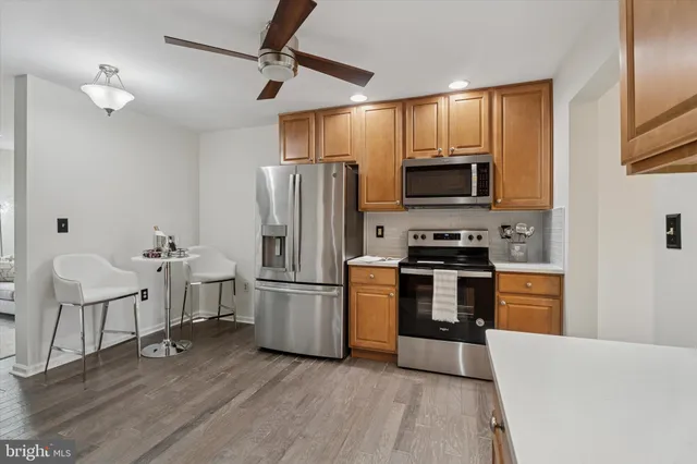 a kitchen with stainless steel appliances a refrigerator microwave and stove