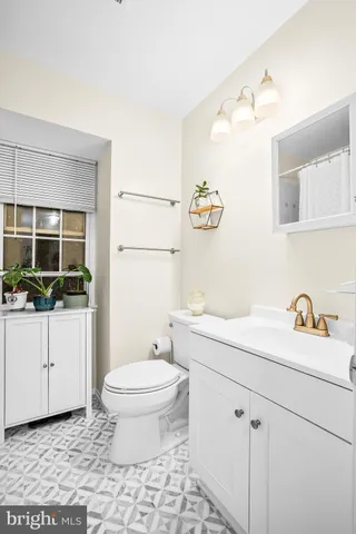 a bathroom with a sink a toilet and mirror