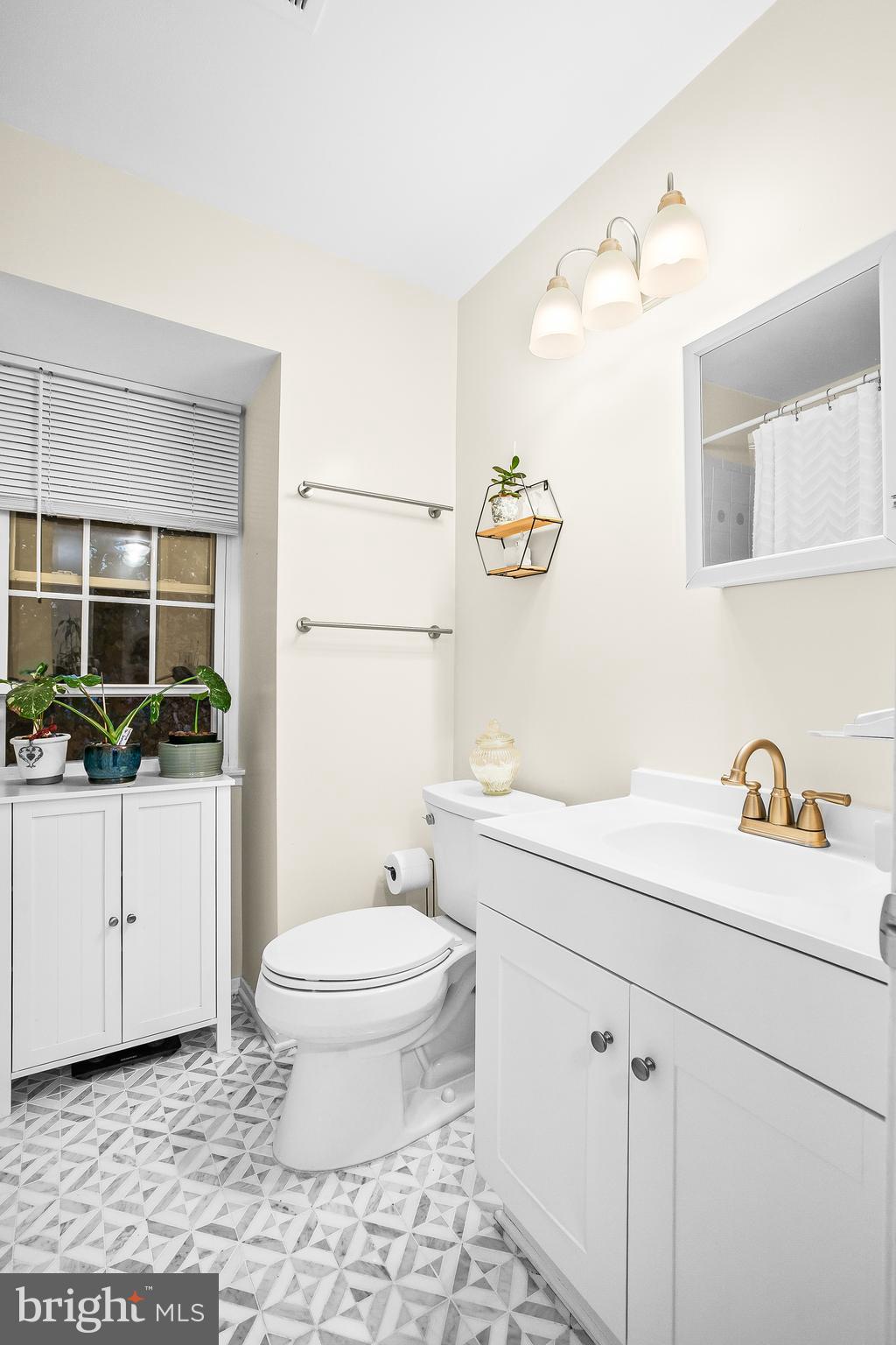 2418 Ridgehampton Court Reston, VA 20191 - Photo 13 of 28 a bathroom with a sink a toilet and mirror