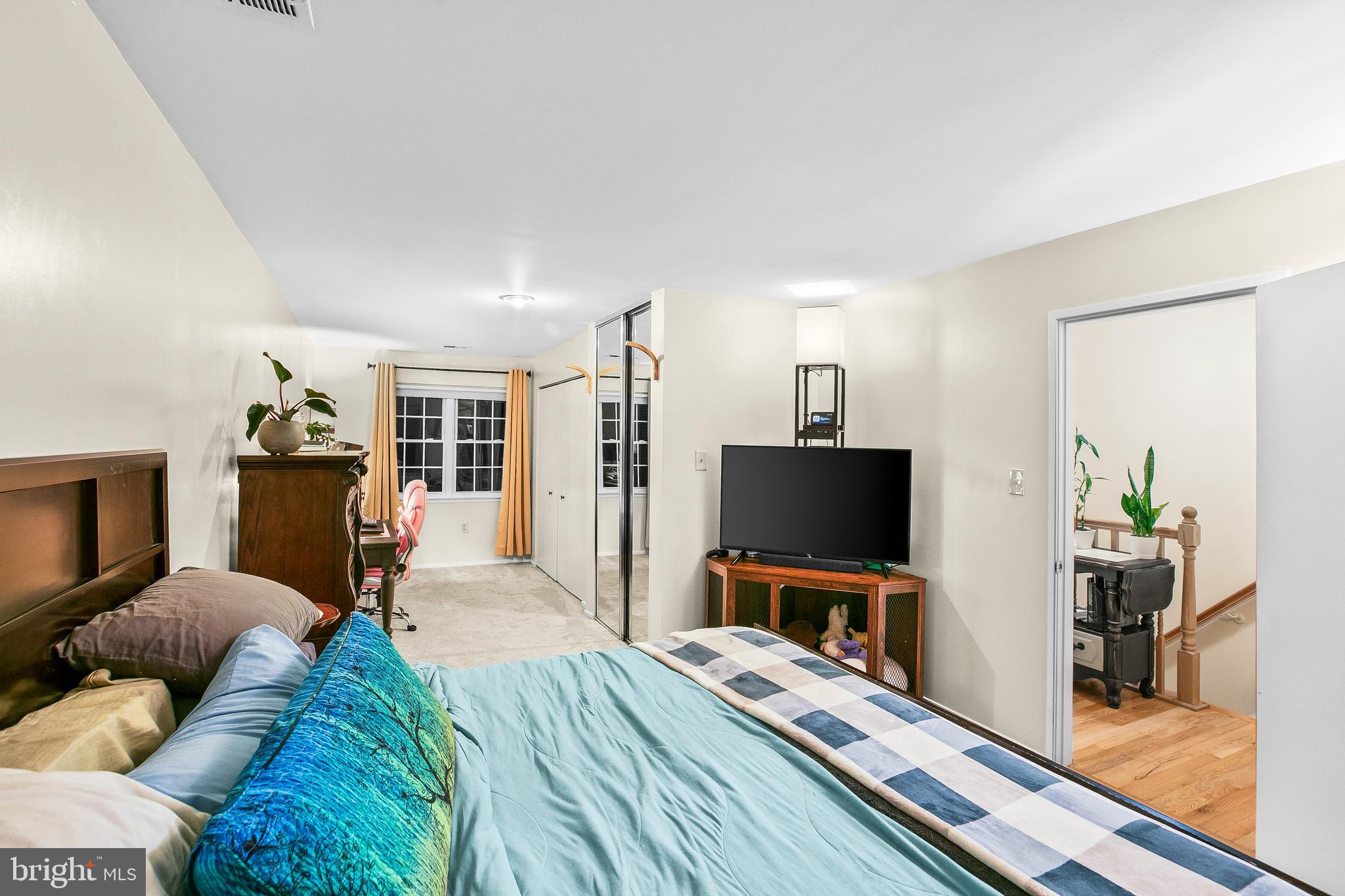 2418 Ridgehampton Court Reston, VA 20191 - Photo 15 of 28 a bedroom with a bed and a flat screen tv