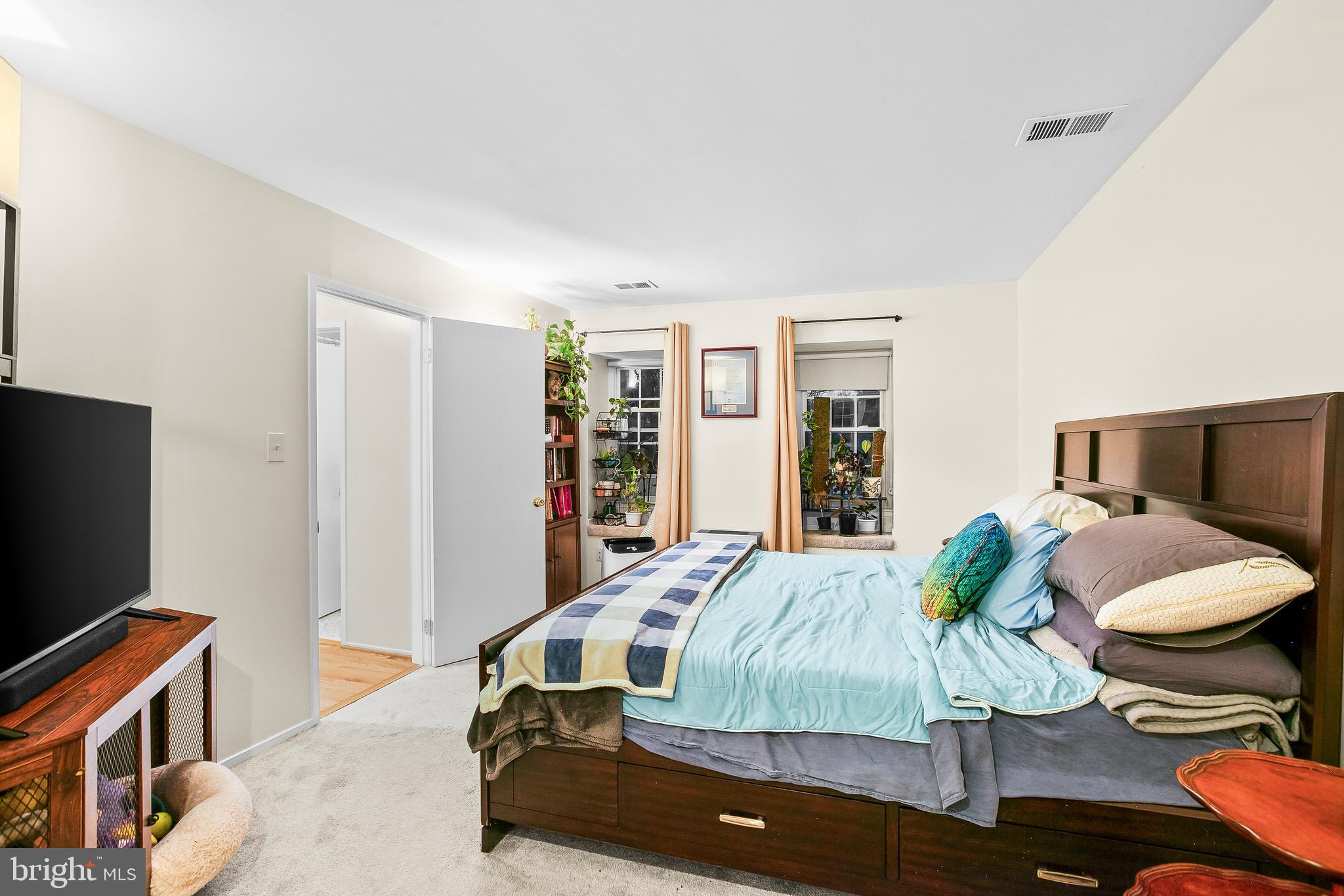 2418 Ridgehampton Court Reston, VA 20191 - Photo 17 of 28 a bedroom with a bed and a flat screen tv