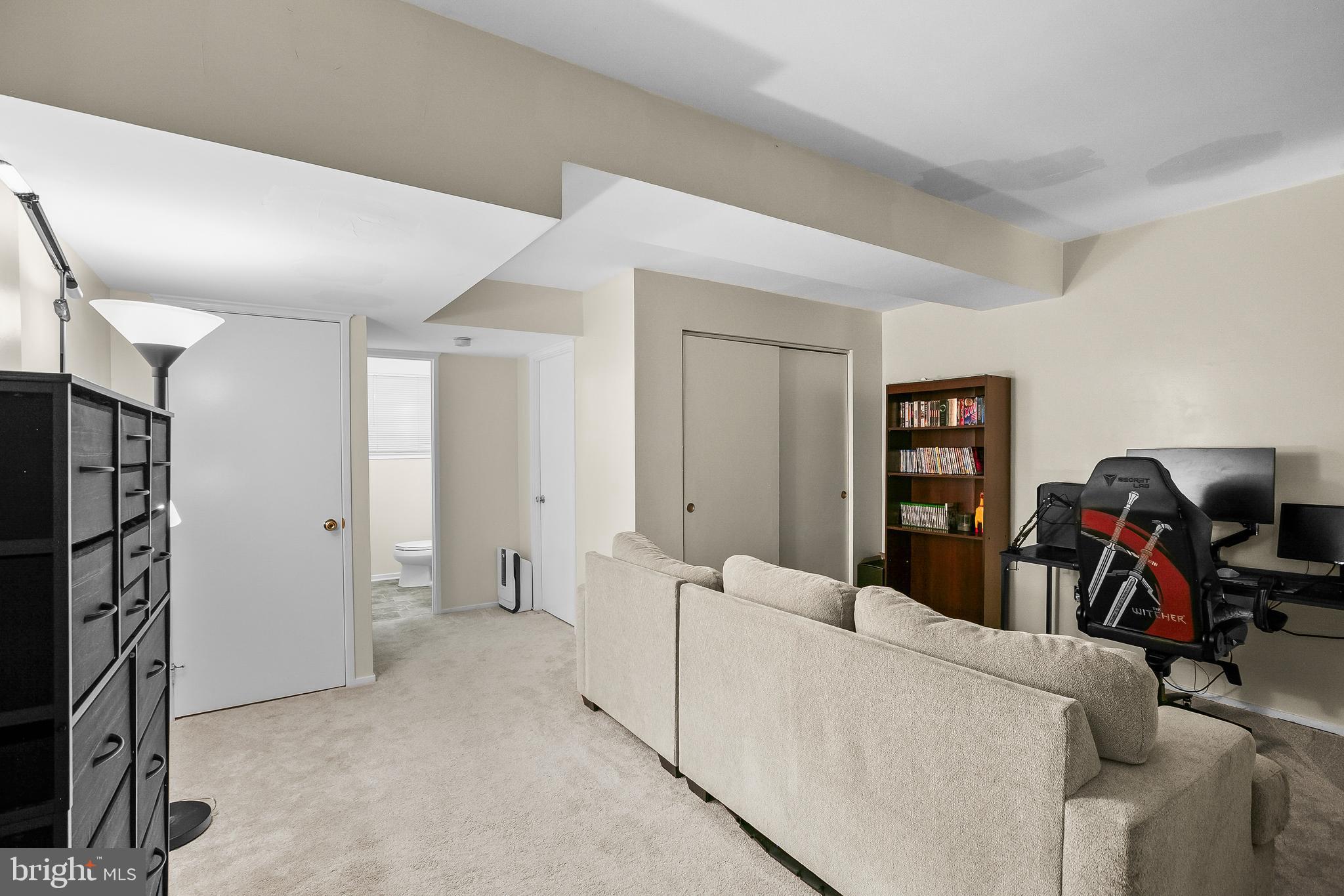 2418 Ridgehampton Court Reston, VA 20191 - Photo 20 of 28 a living room with furniture and a flat screen tv