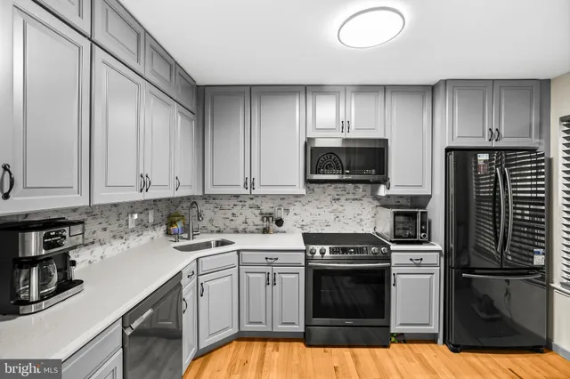 a kitchen with a sink stove and microwave