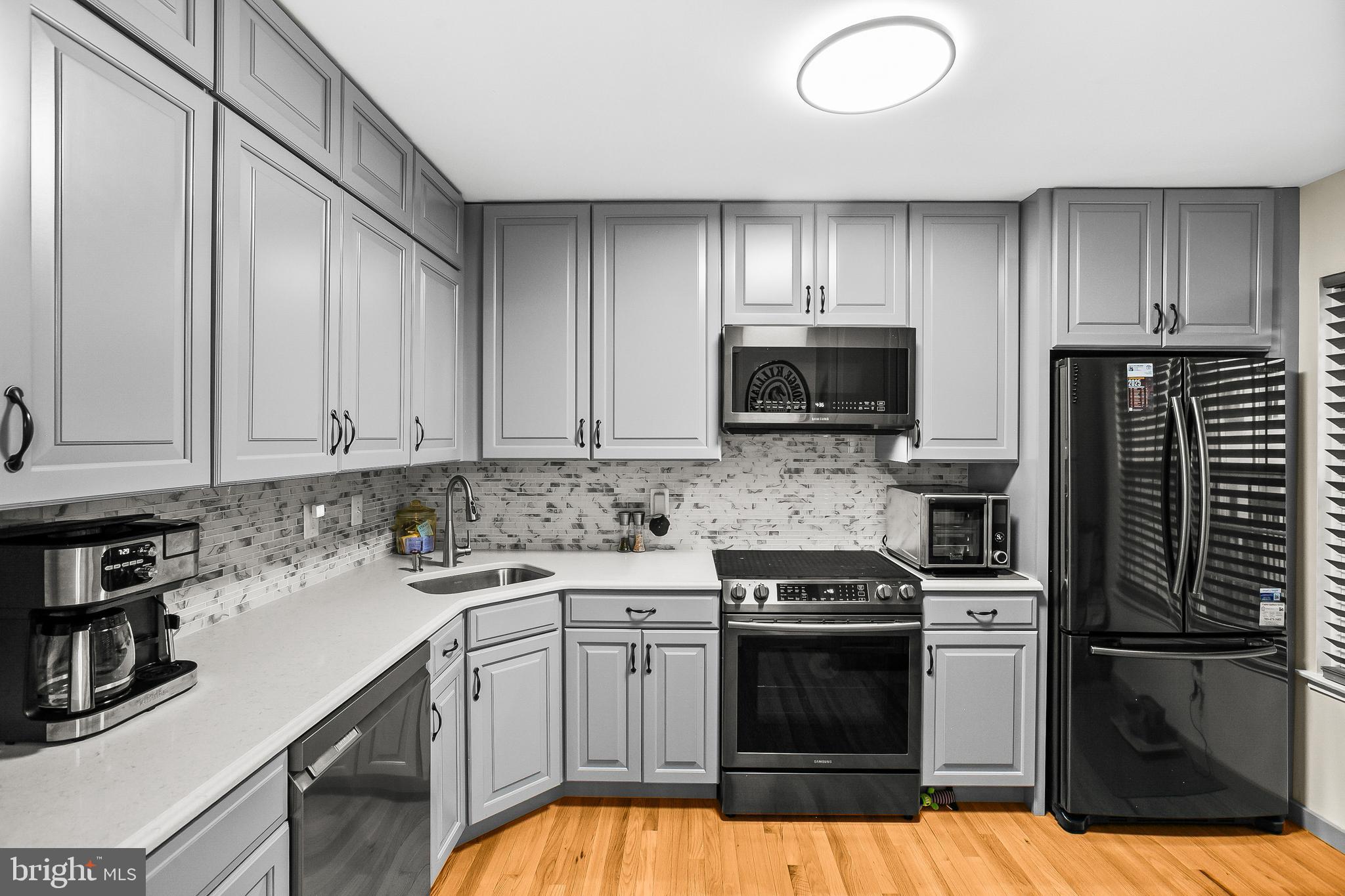 2418 Ridgehampton Court Reston, VA 20191 - Photo 2 of 28 a kitchen with a sink stove and microwave