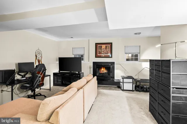 a living room with furniture a fireplace and a flat screen tv