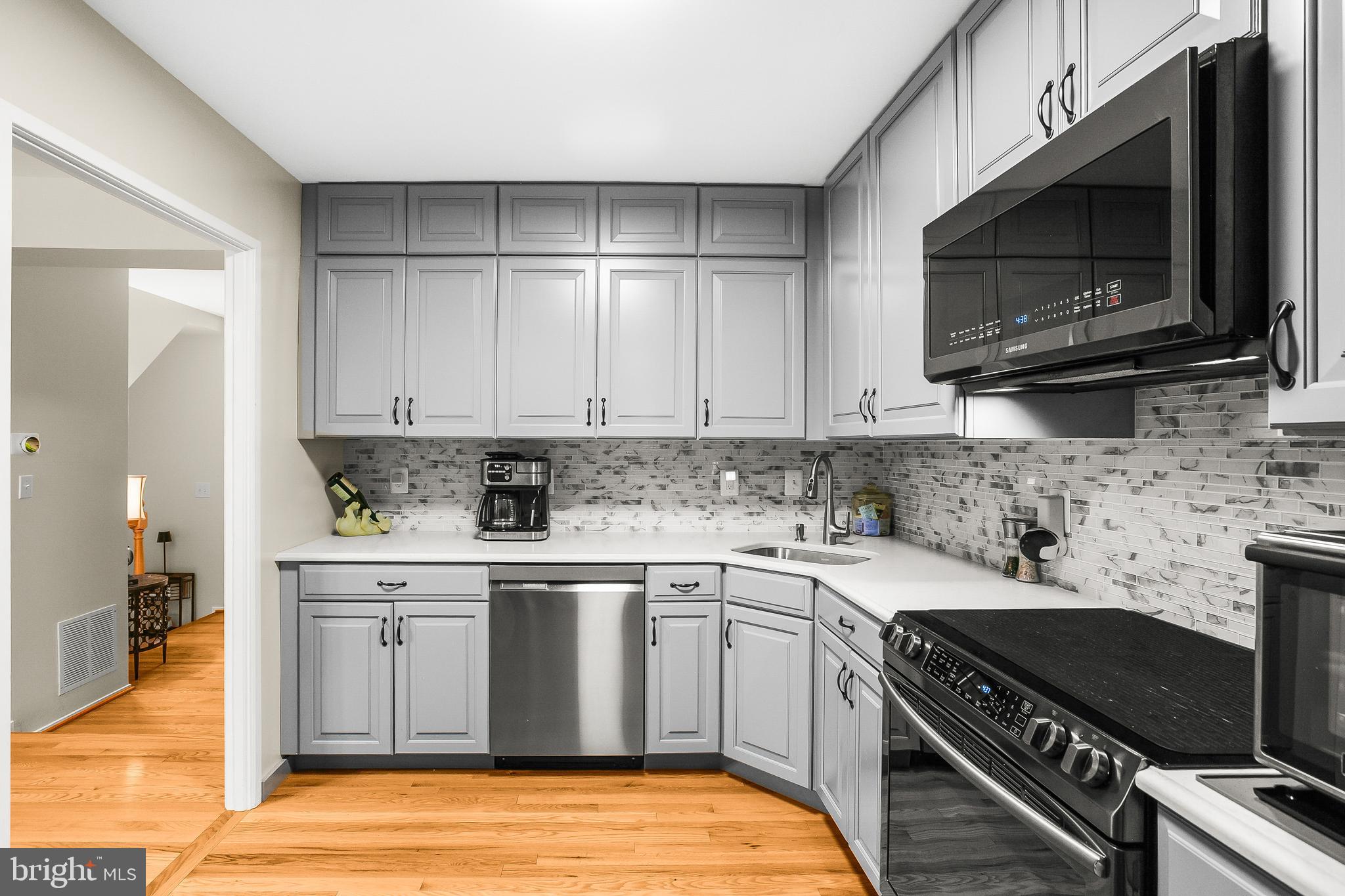 2418 Ridgehampton Court Reston, VA 20191 - Photo 4 of 28 a kitchen with a sink stove and microwave