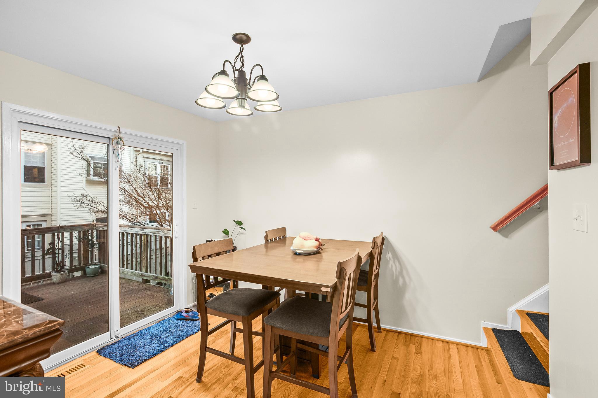 2418 Ridgehampton Court Reston, VA 20191 - Photo 9 of 28 a view of a dining room with furniture wooden floor and chandelier