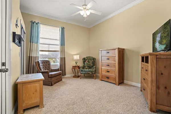 a living room with furniture and a flat tv screen