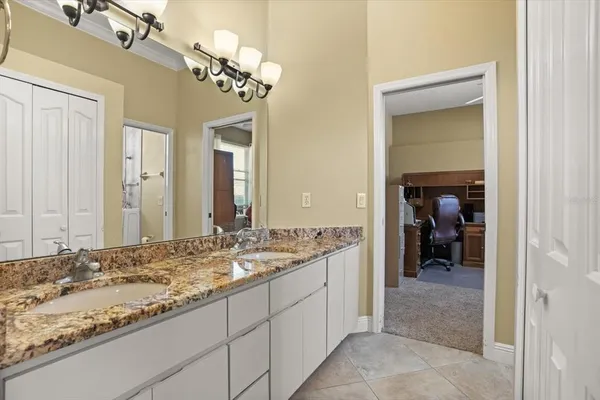 a bathroom with a granite countertop toilet sink and shower