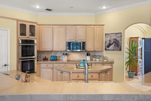 a kitchen with stainless steel appliances granite countertop a large counter top space a stove and cabinets