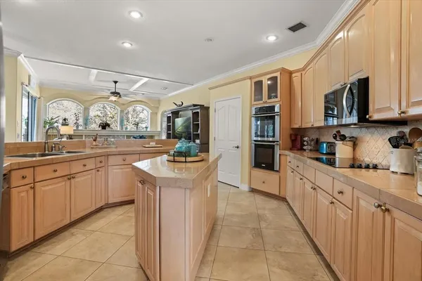 a kitchen with a sink stove and cabinets