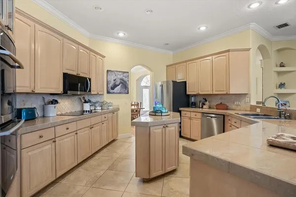 a living room with furniture a fireplace and a chandelier