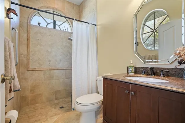 a bathroom with a toilet sink and mirror