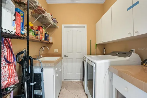 a view of a patio with a table and chairs and potted plants