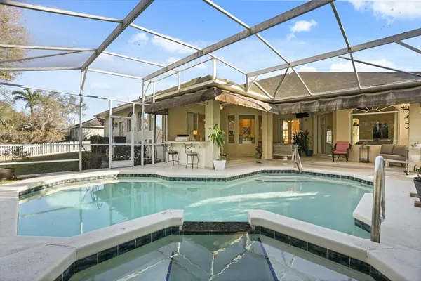 a view of a swimming pool with outdoor seating
