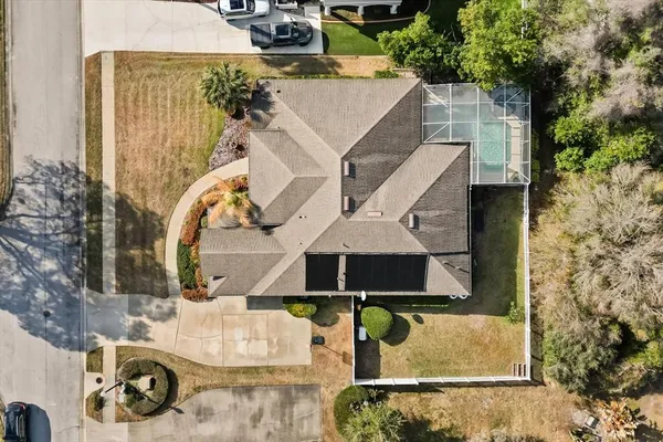 an aerial view of a house with a swimming pool