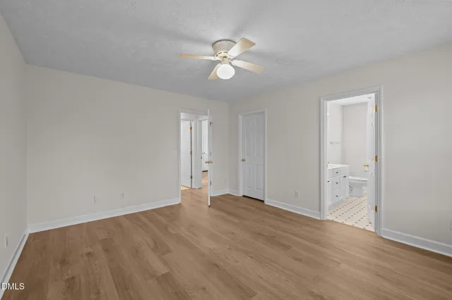 a view of an empty room and wooden floor