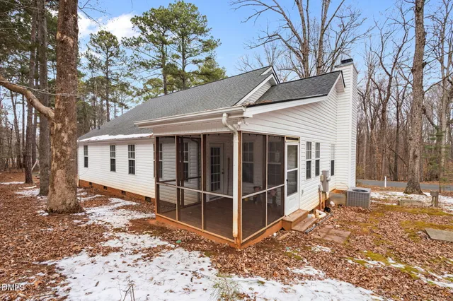 a view of a house with a yard covered in snow