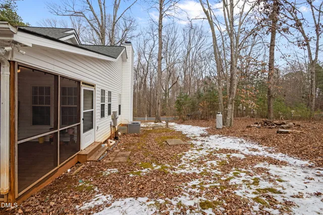 a view of a backyard with a large tree