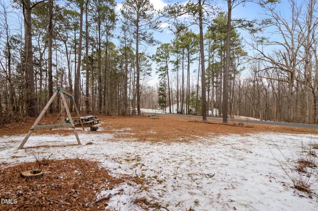 a view of outdoor space with playground and green space