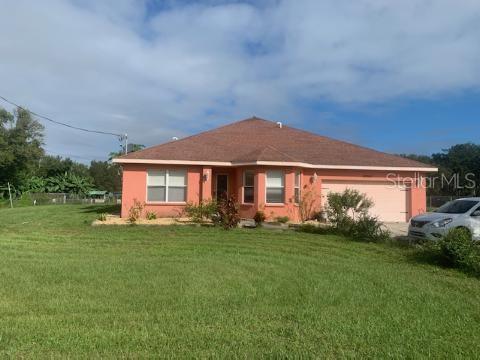 12015 Lithia Pinecrest Road Lithia, FL 33547 - Photo 1 of 1 a front view of a house with a garden