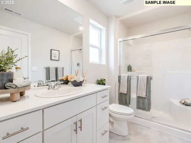 a bathroom with a double vanity sink toilet and shower