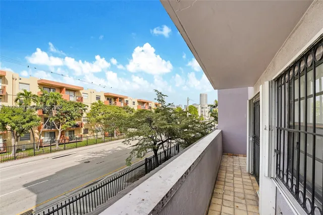 a view of a patio with couches and potted plants