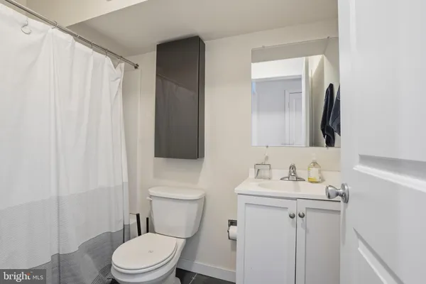 a white toilet sitting next to a bathroom sink