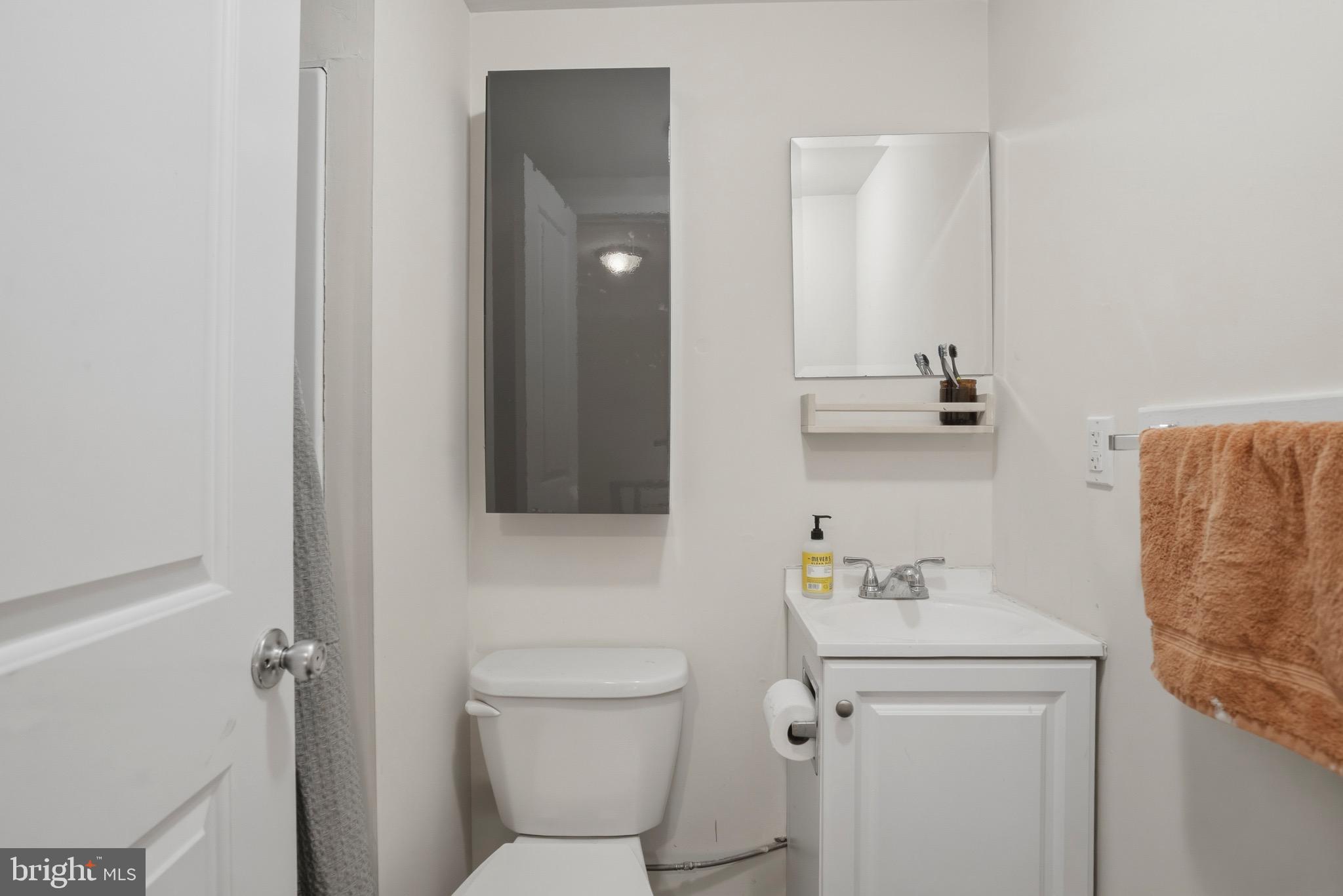 520 South 4th Street, Unit C Philadelphia, PA 19147 - Photo 14 of 18 a bathroom with a toilet sink and mirror