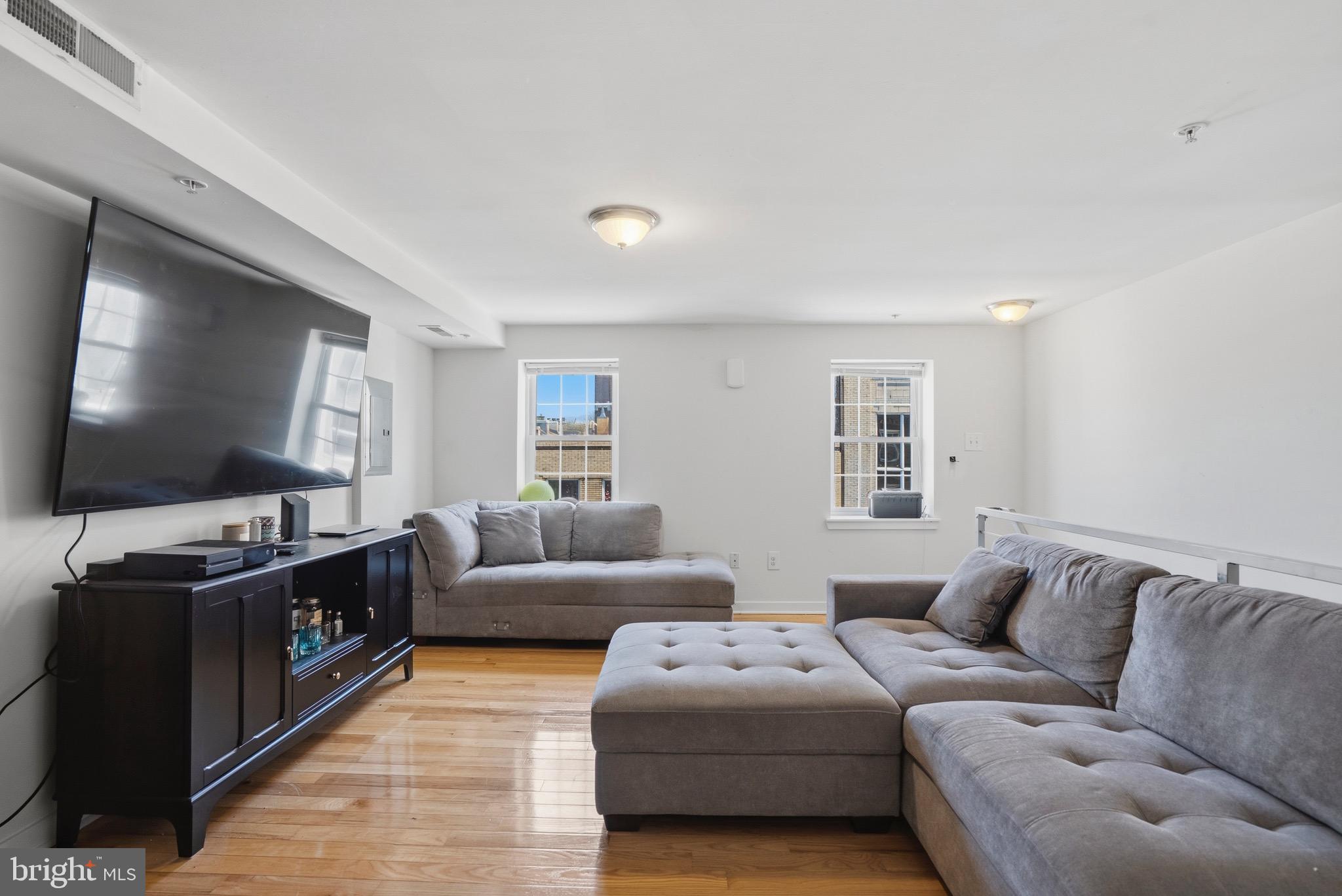 520 South 4th Street, Unit C Philadelphia, PA 19147 - Photo 3 of 18 a living room with furniture and a flat screen tv