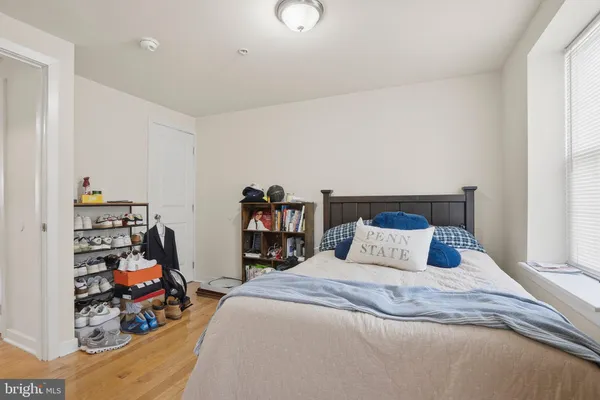a bedroom with bed and a closet